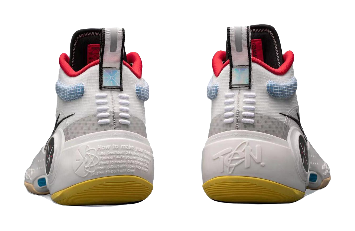 White mid-top basketball sneakers back view with red heel tabs and yellow outsole