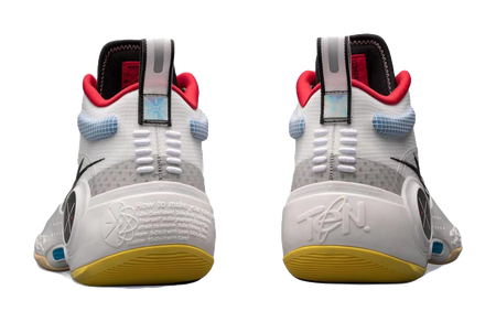 White mid-top basketball sneakers back view with red heel tabs and yellow outsole