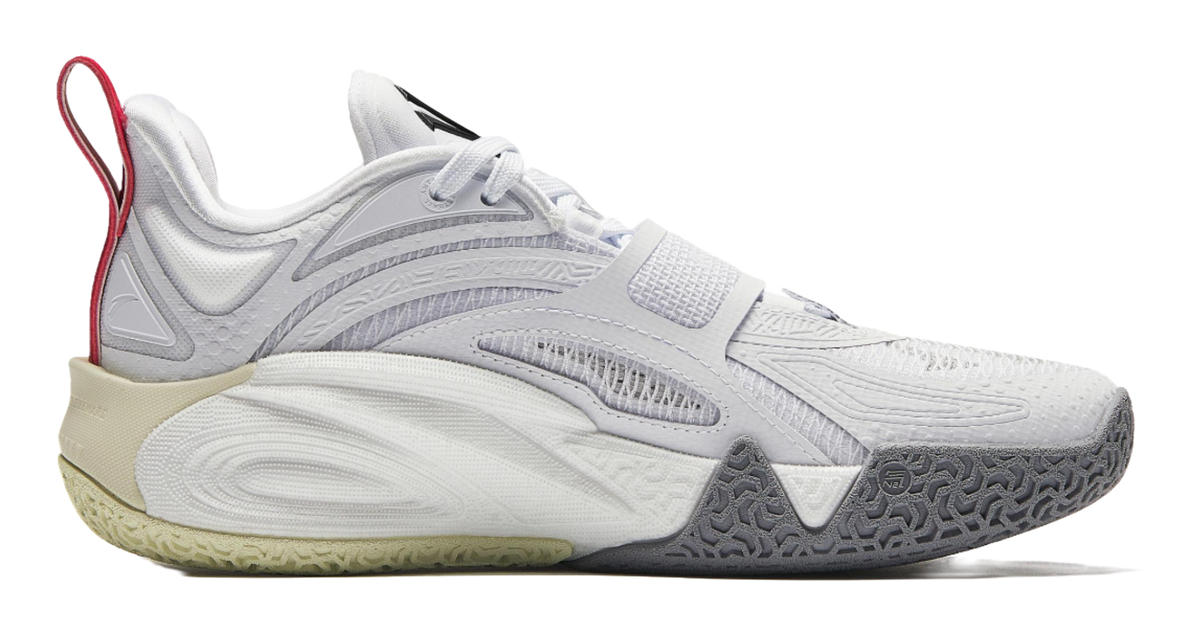 White basketball shoe with lace-up front, beige midsole, dark rubber outsole.