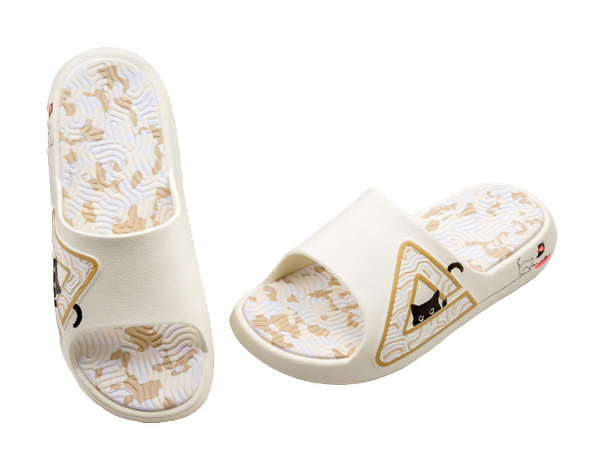 White slide sandal showing interior footbed and outsole with triangular cat emblem