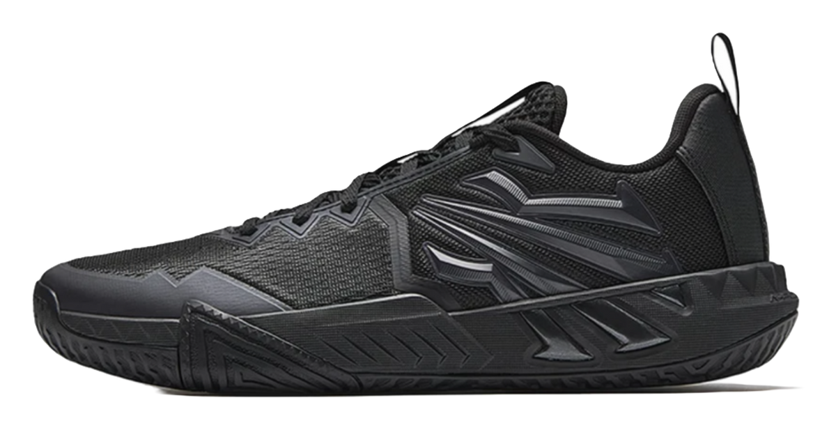 Black low-top basketball shoes with textured knit upper and lace-up closure