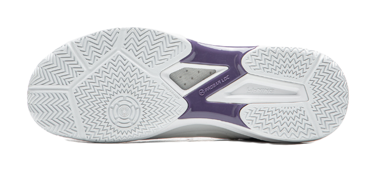 Outsole of a white and purple table tennis shoe with zigzag tread pattern