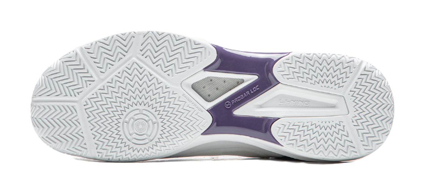 Outsole of a white and purple table tennis shoe with zigzag tread pattern