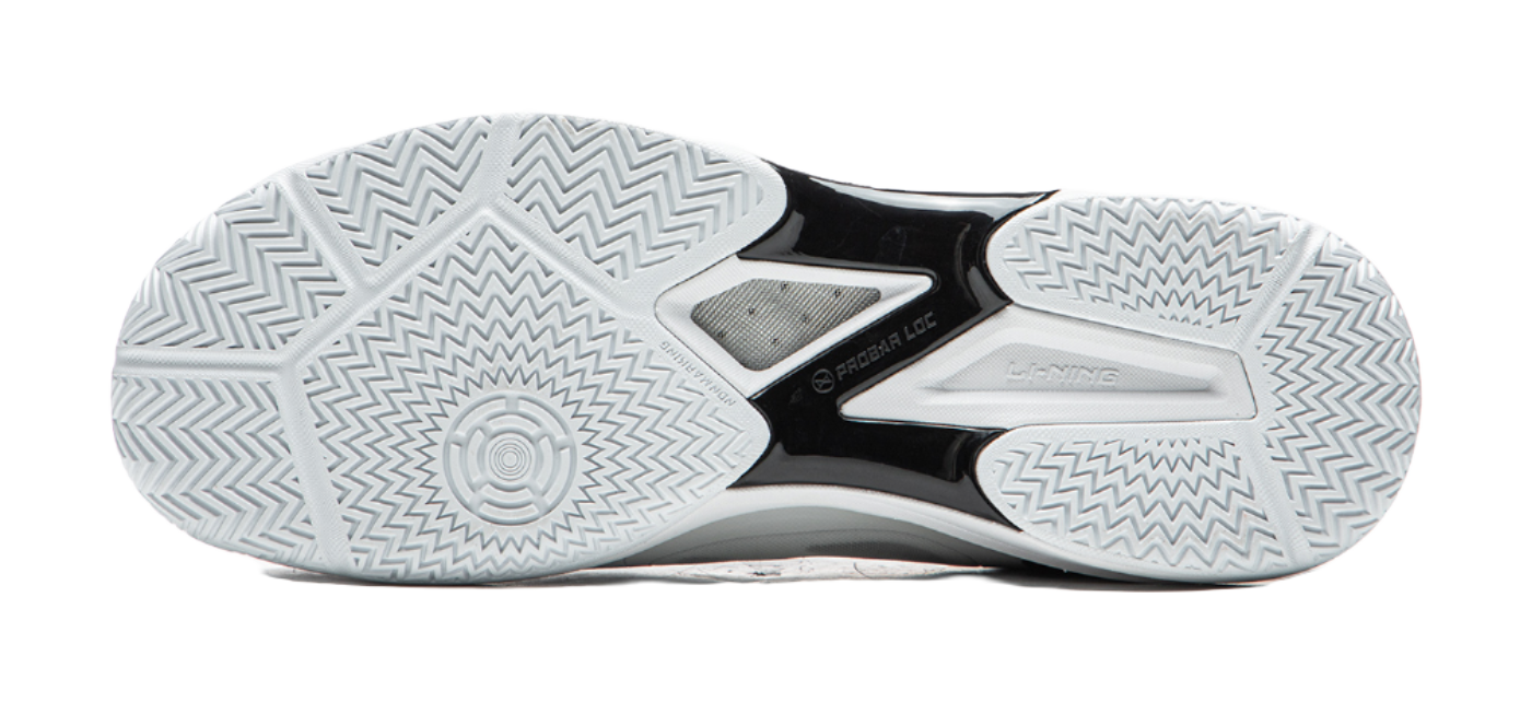 Outsole of white table tennis shoe with zigzag traction pattern