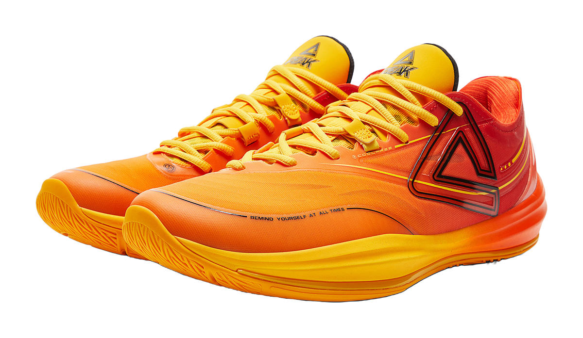 Basketball shoes pair with orange/yellow lace-up uppers and black side emblem