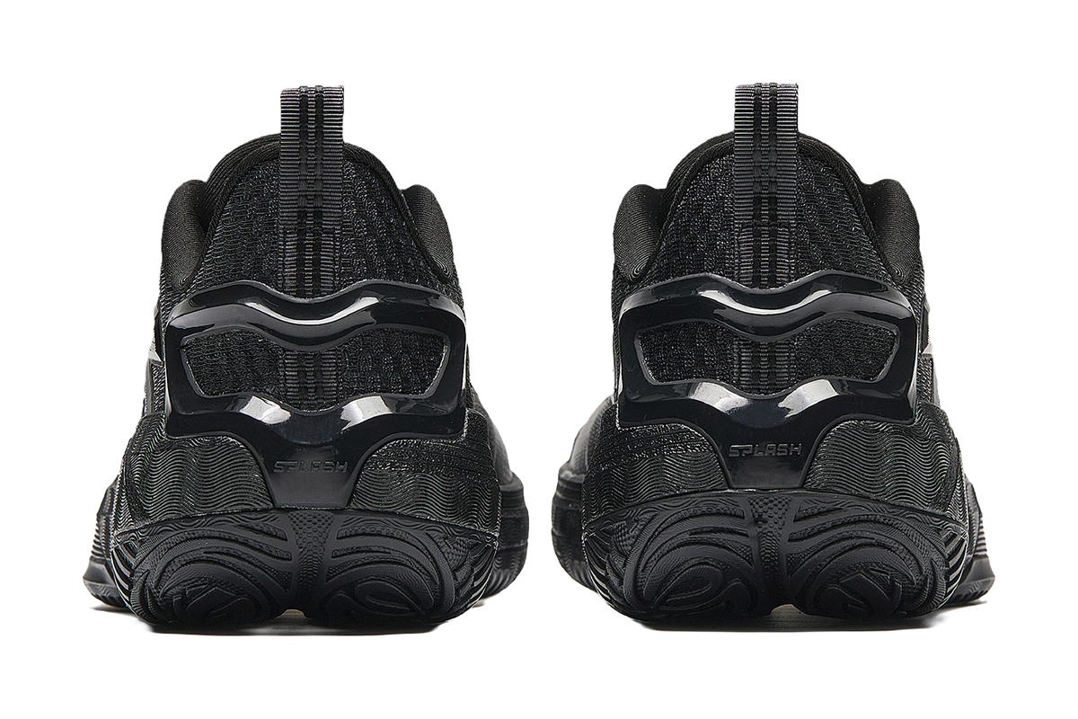 Low-top basketball sneakers, rear view showing black heel and thick molded outsole