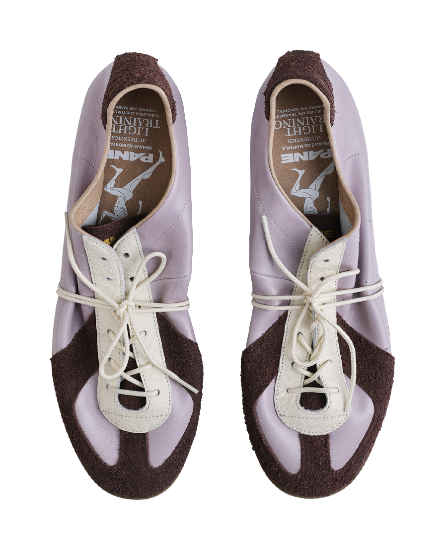 Lavender lace-up low-top shoes with white eyelets and dark brown heel lining, gum sole