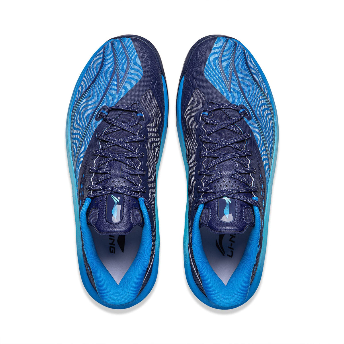 Pair of basketball shoes shown from above: blue interior lining, navy laces, wave-pattern uppers