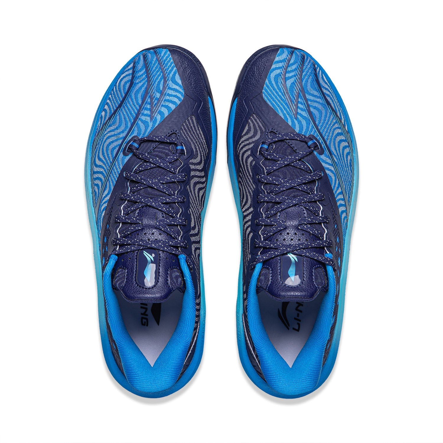 Pair of basketball shoes shown from above: blue interior lining, navy laces, wave-pattern uppers