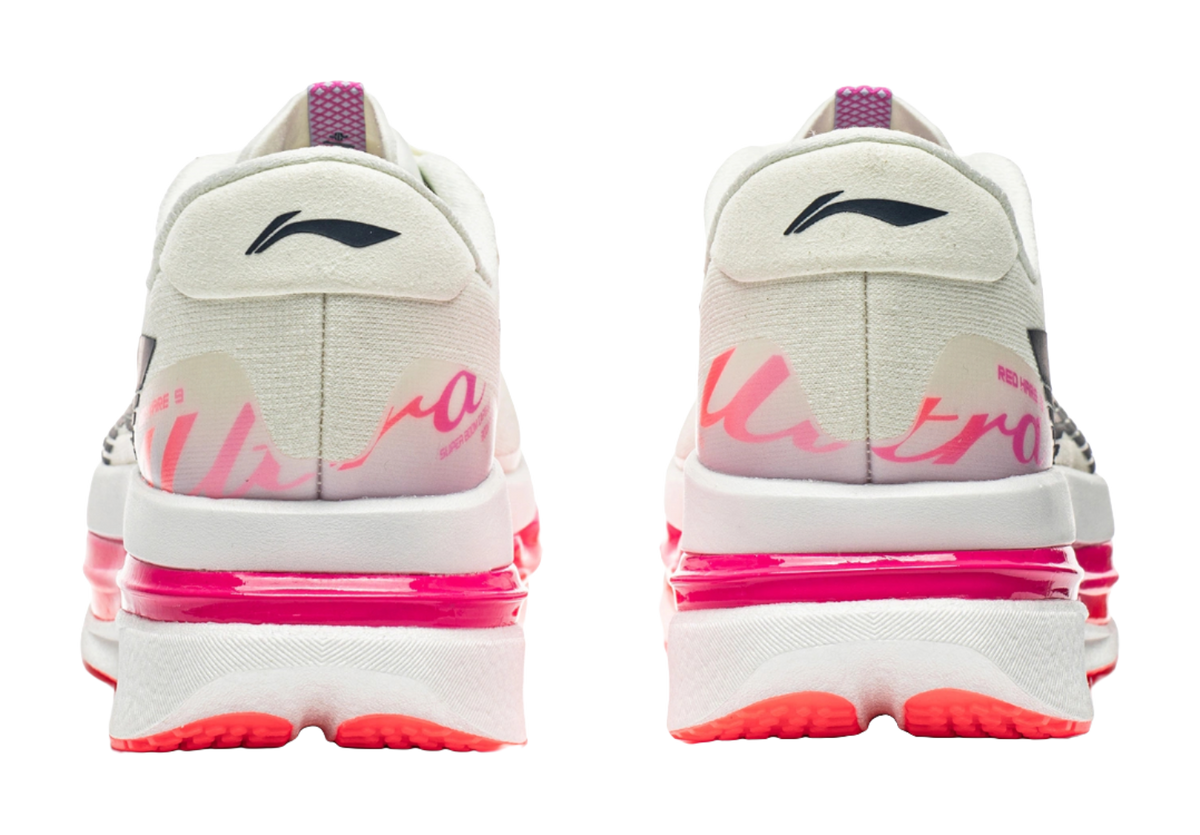 Men's low-top running shoes, white heel with pink accents and red outsole grip pods