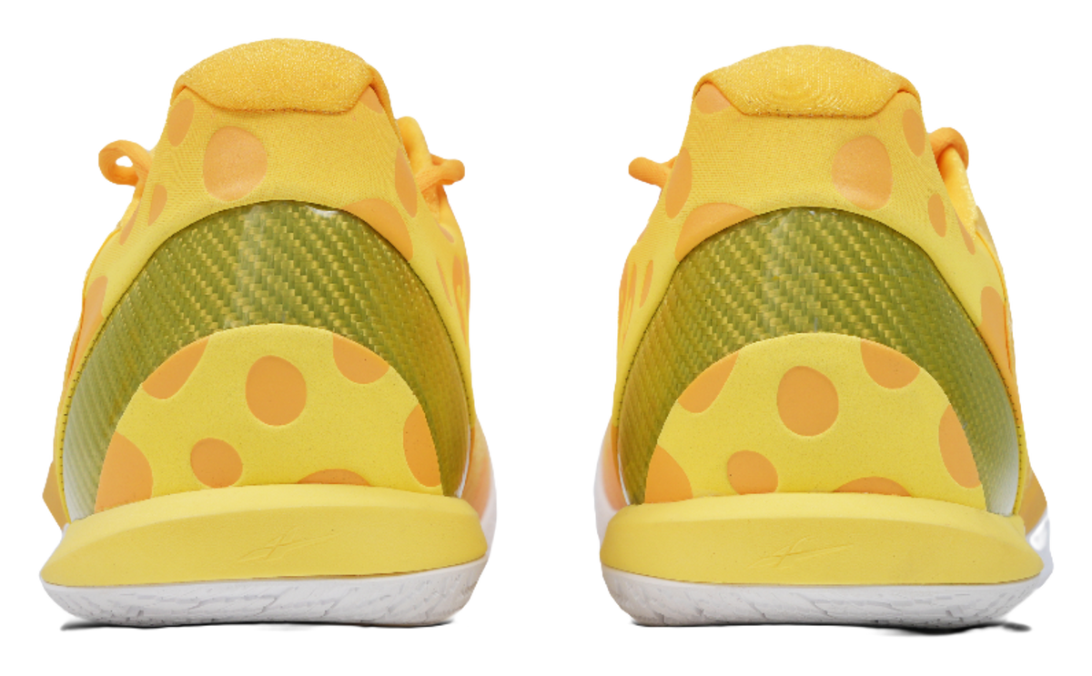 Low-top basketball shoes, heel view with green lining and yellow polka panels