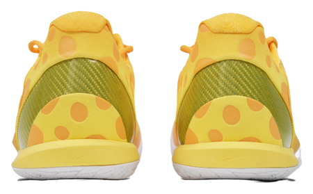 Low-top basketball shoes, heel view with green lining and yellow polka panels