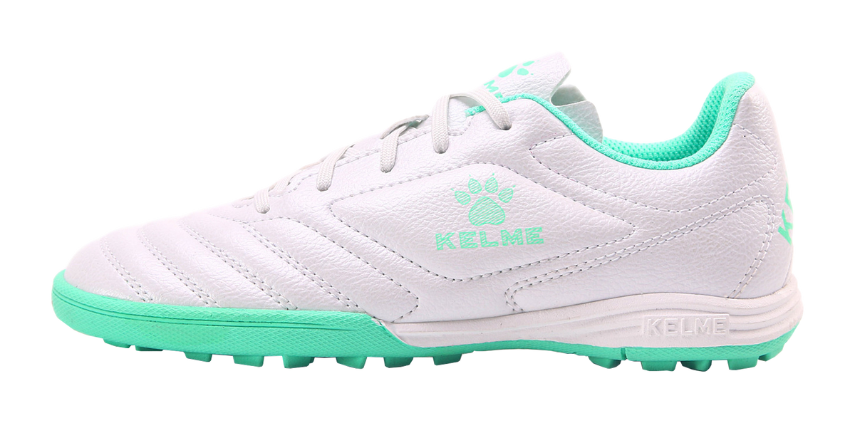 Kelme TF training soccer shoes, white uppers with mint green accents, lace-up.