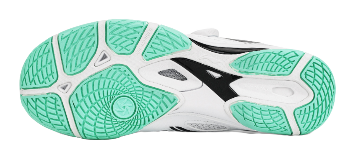 Table tennis shoe outsole in mint green with textured traction pattern over white base