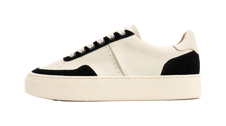 Low-top skate shoes, off-white upper with black panels, lace-up, platform sole.