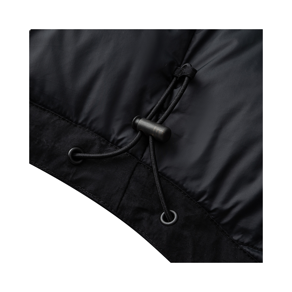 Black jacket drawstring with metal toggles and eyelets at hem.