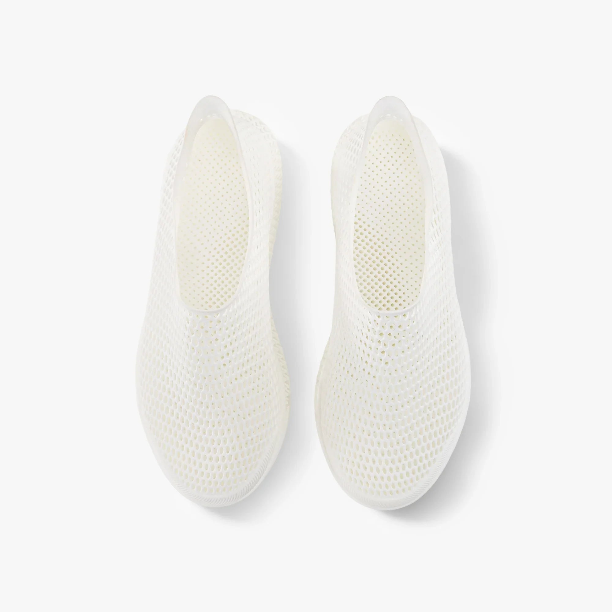 Off-white slip-on sneakers, rear view showing textured mesh footbed and heel