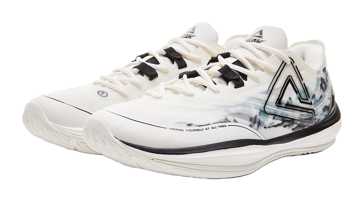 Lightweight basketball shoe, cream upper with black strap details and blue-gray side graphic