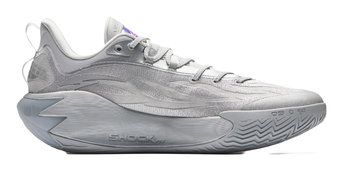 Metallic grey basketball shoe, side view with textured sole and lace-up upper