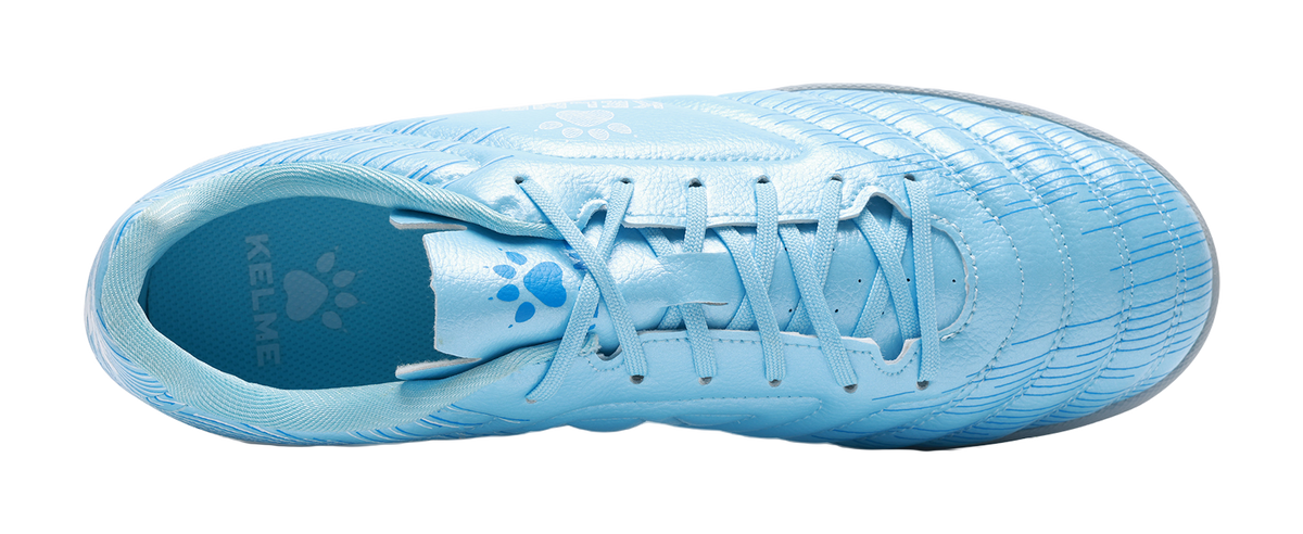 Sky blue unisex TF turf soccer shoe top view with KELME and paw-pattern accents