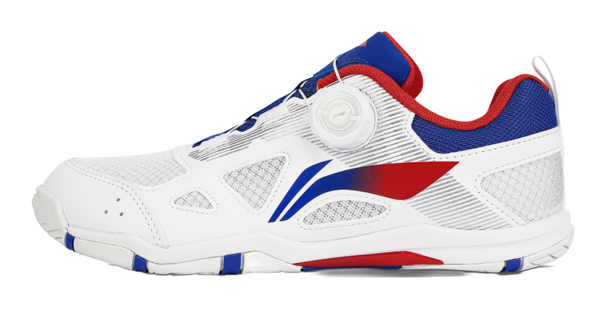 Table tennis shoe in white with blue and red accents, low-profile side view