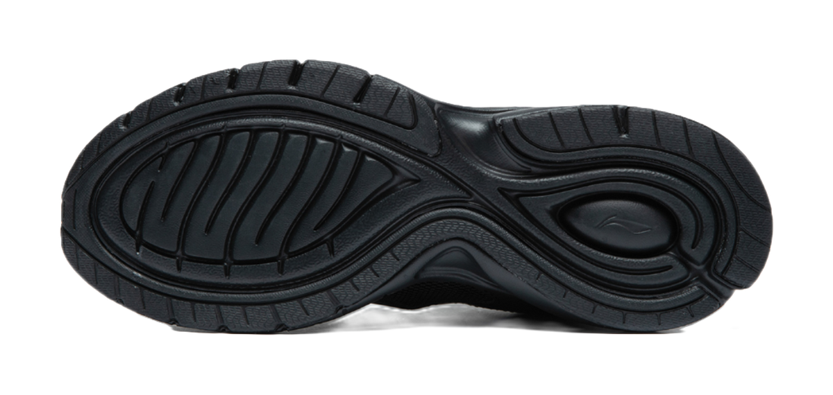Black rubber outsole with tread pattern and cushioning ridges under running shoe.