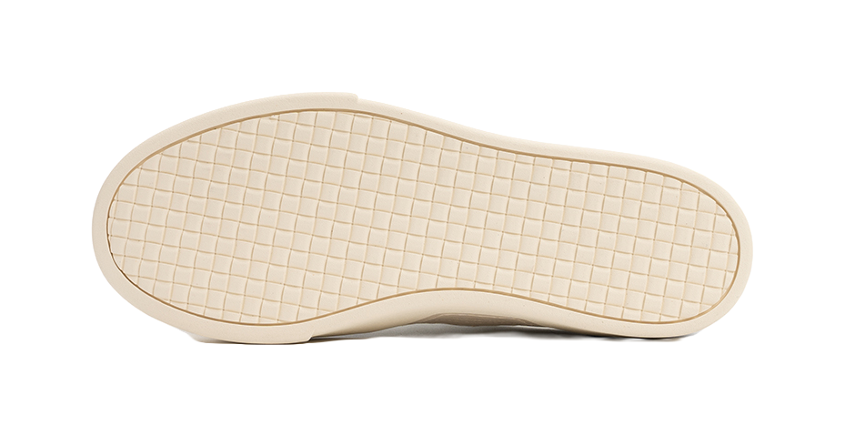 Shoe outsole, light off-white rubber tread with grid pattern, platform skate sole.