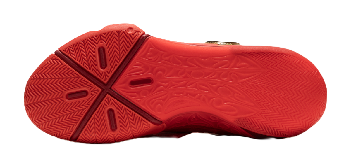 Red basketball shoe outsole with traction tread pattern.