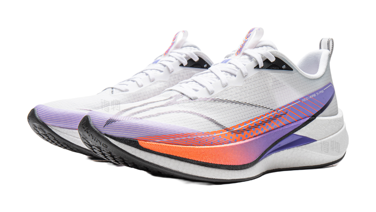 Pair of white running shoes with purple overlays and orange-blue wave graphics