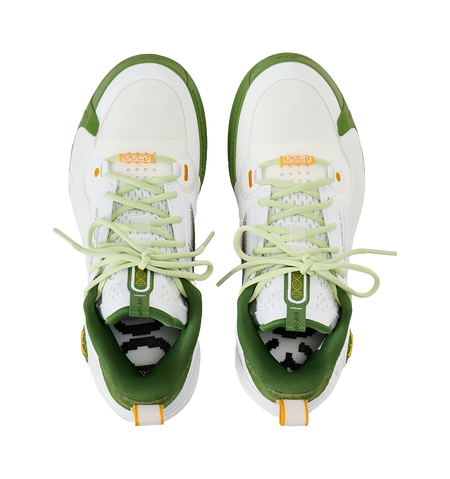 Pair of white low-top basketball shoes with light green laces and green inner lining.