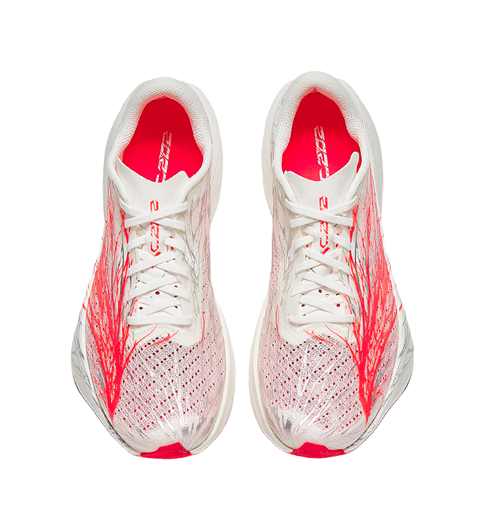 White/red lace-up running shoes, textured knit upper with red heel lining.