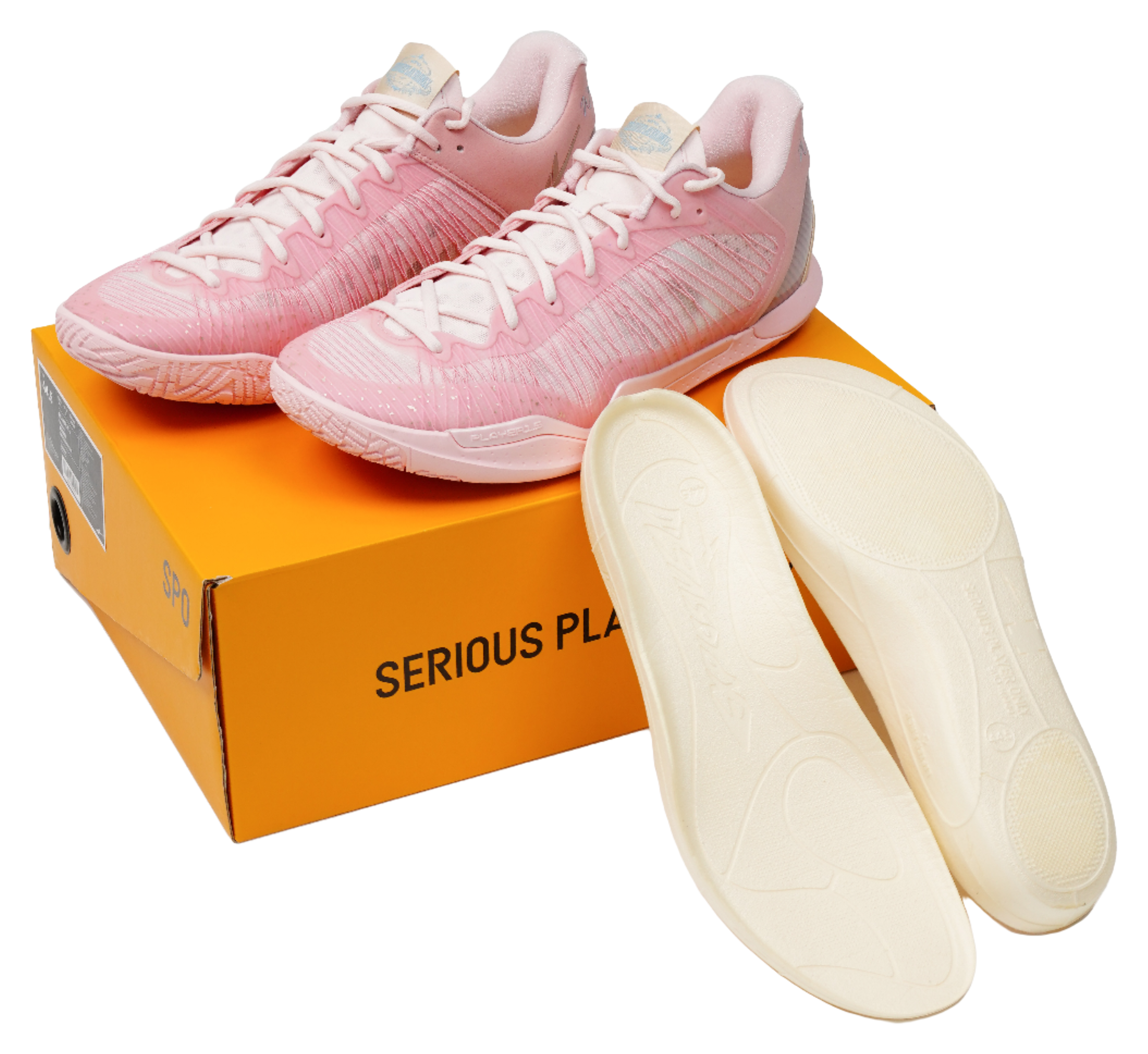 Pink basketball shoes with matching insoles, resting on an orange logo box
