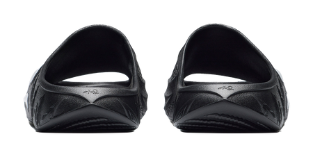 Men's black slide slippers, heel view with molded cushioning and subtle brand marks