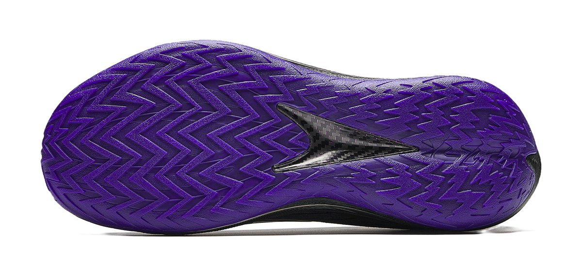 Purple basketball shoe outsole with zigzag traction pattern and oval forefoot cutout