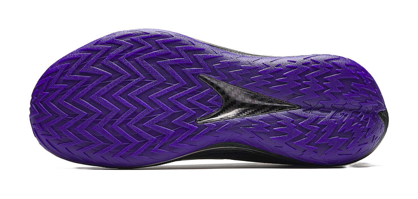 Purple basketball shoe outsole with zigzag traction pattern and oval forefoot cutout