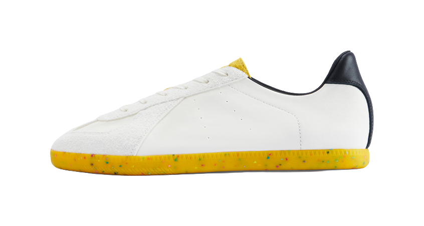 White low-top leather training shoes with yellow speckled rubber sole