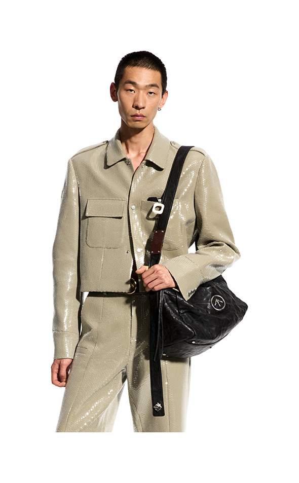 Black pleated leather crossbody bag with flap and front logo emblem.
