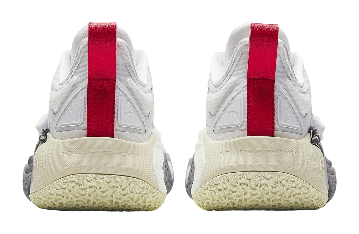 Heels of white basketball shoes with red straps and textured beige rubber outsole.
