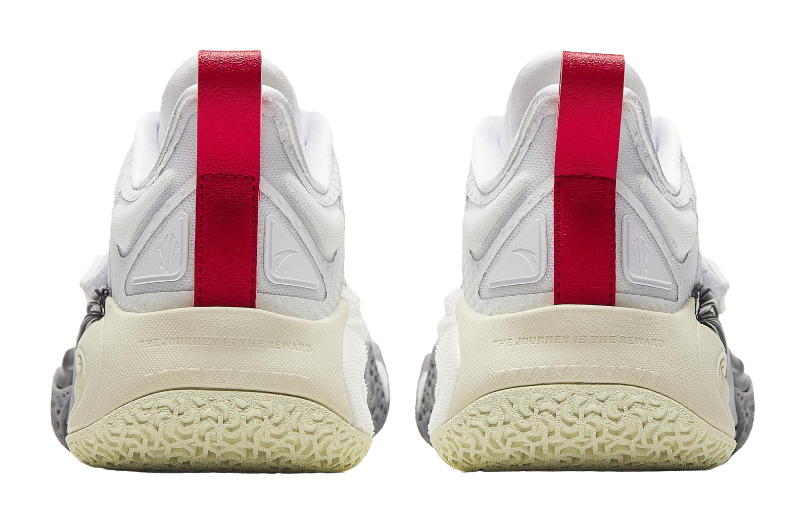 Heels of white basketball shoes with red straps and textured beige rubber outsole.