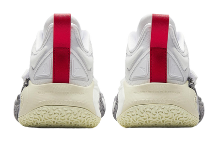 Heels of white basketball shoes with red straps and textured beige rubber outsole.