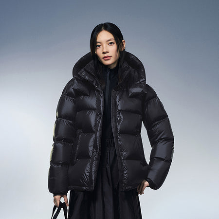 Black hooded puffer winter down jacket worn with full-length button placket