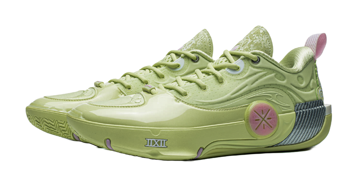 Green basketball shoe angled view with lace-up and pink circular emblem on side