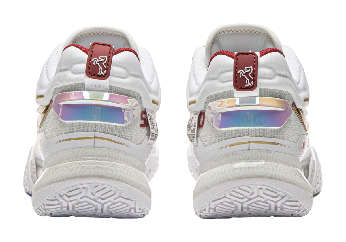 Back view of white and red badminton shoes with heel strap and durable outsole