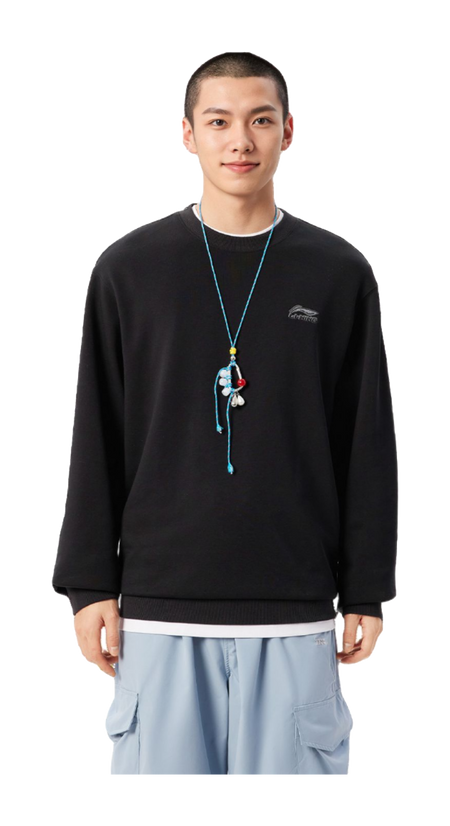 Black crewneck sweatshirt on model, long sleeves with small chest logo; ribbed hem.