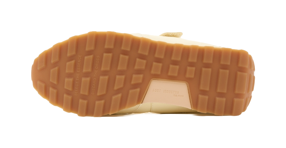 Light yellow Mary Jane shoe outsole with textured traction pattern