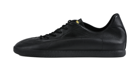 Black low-top training sneaker with black laces and smooth leather upper