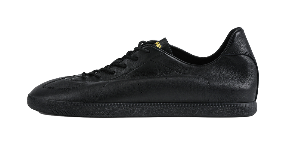 Black low-top training sneaker with black laces and smooth leather upper