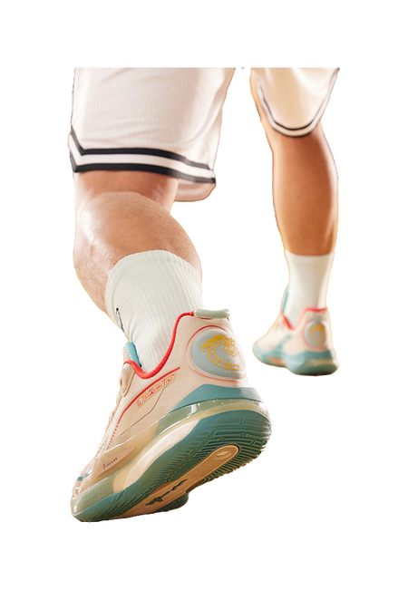 Side view of unisex basketball shoe on foot; oat beige upper with teal sole