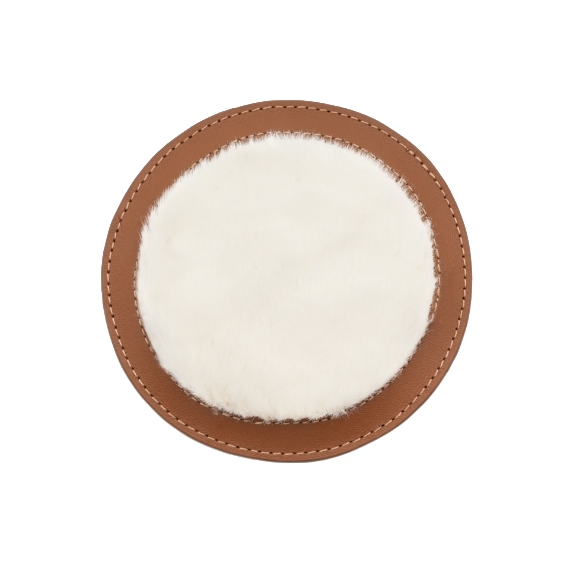 Brown circular leather patch on shoe dust bag with white plush center