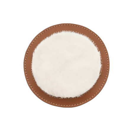 Brown circular leather patch on shoe dust bag with white plush center